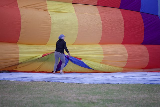 Ground Crew Prepares Rainbow Hot Air Balloon for Launch