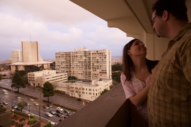 Couple Gazing From Hotel Balcony at Dusk