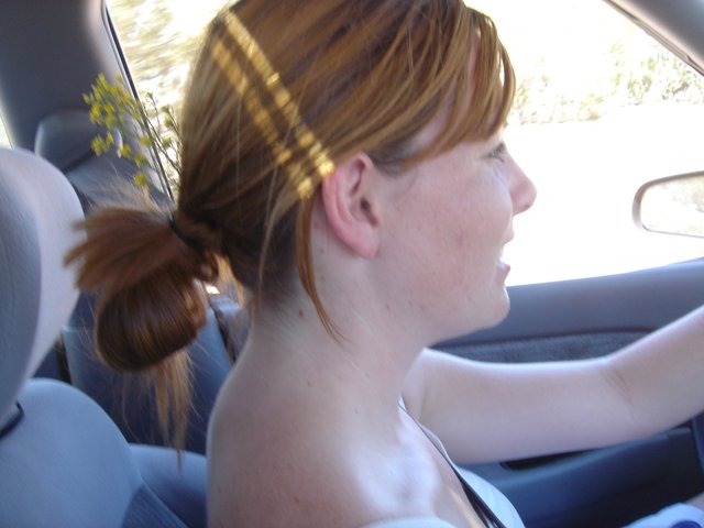 Redhead Woman Driving on a Sunny Afternoon