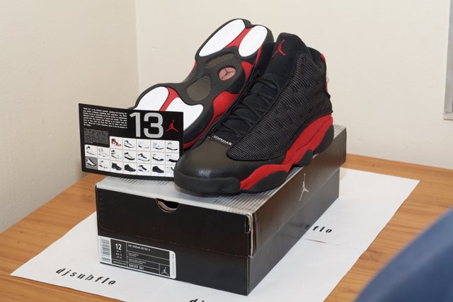 Air Jordan 13 Retro Black Red Sneakers on Hardwood Floor