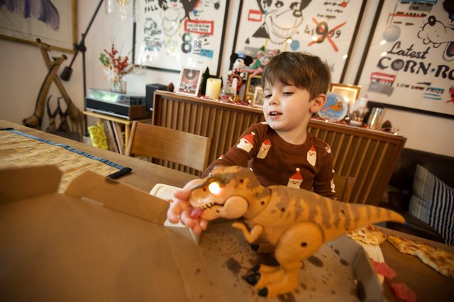 Child Playing with Stuffed Tiger Toy at Christmas Dinner Table