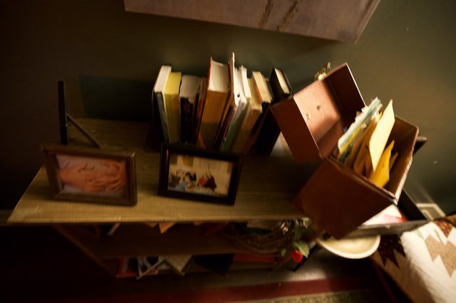 Disorganized Book Collection on Wooden Shelf