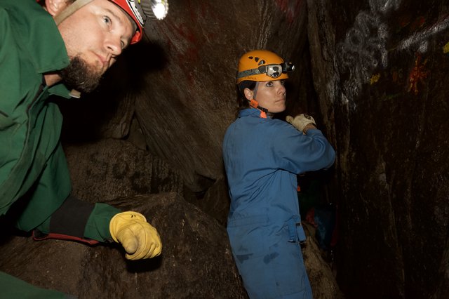 Cavers Navigate Tight Underground Passage Together