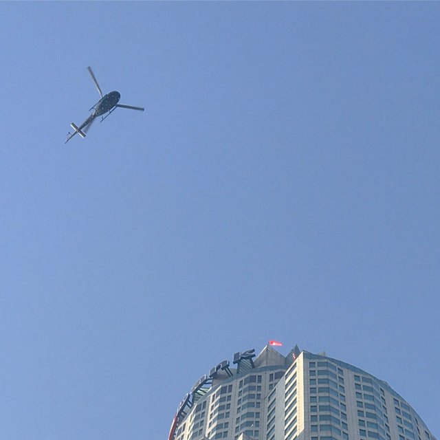 Helicopter Flying Over Los Angeles Skyscraper