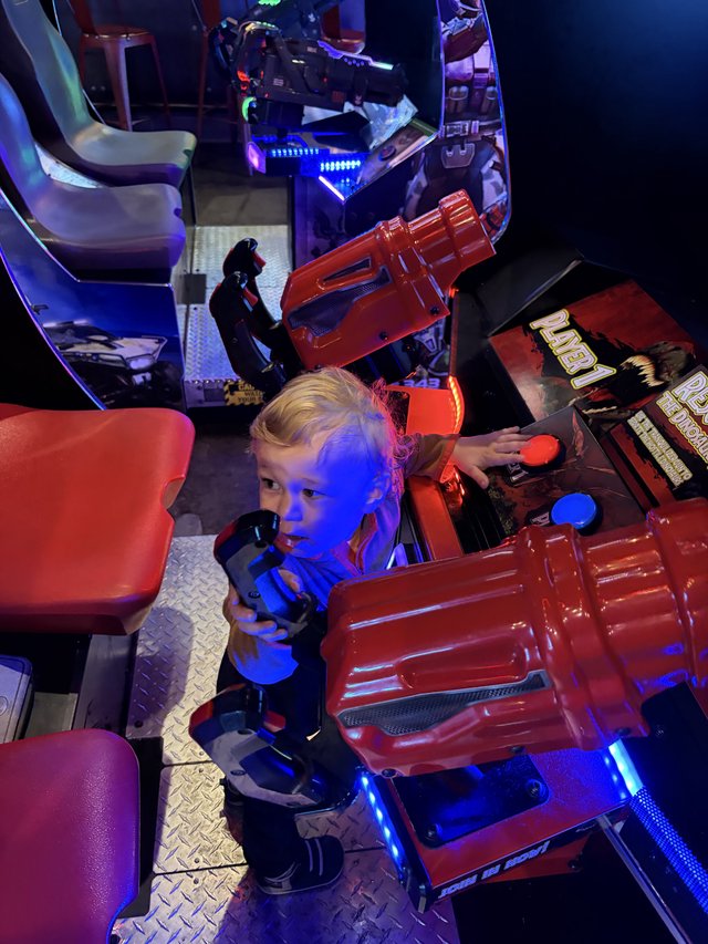 Young Child Exploring Interactive Arcade Racing Game