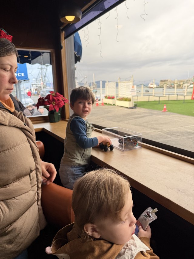 Family Moment at Waterfront Cafe During Winter Holidays