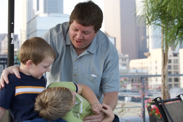 Father Bonding with Two Young Boys Outdoors