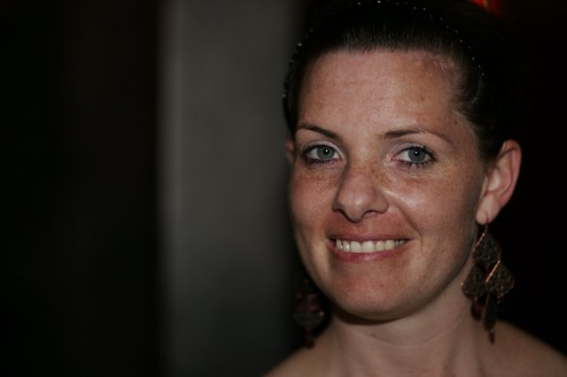 Freckled Woman Smiling Warmly at Evening Event