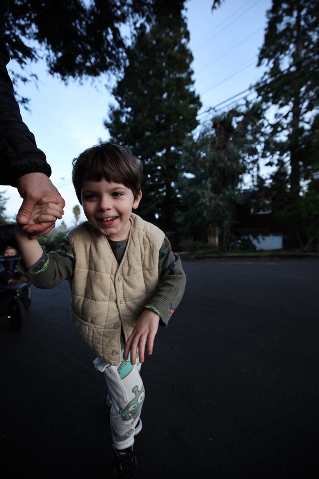 Joyful Child Holding Parent's Hand at Dusk