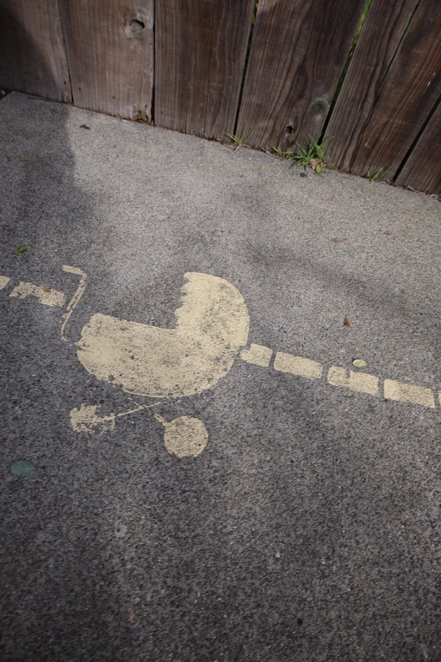 Spray Painted Stencil Art on Urban Sidewalk