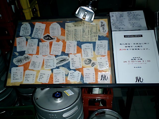 A Table Full of Beer Kegs and Menu Sign in Tokyo