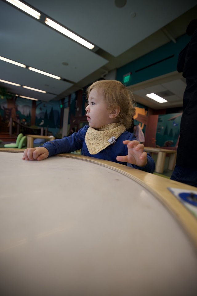 Toddler's Curious Moment at Interactive Learning Table