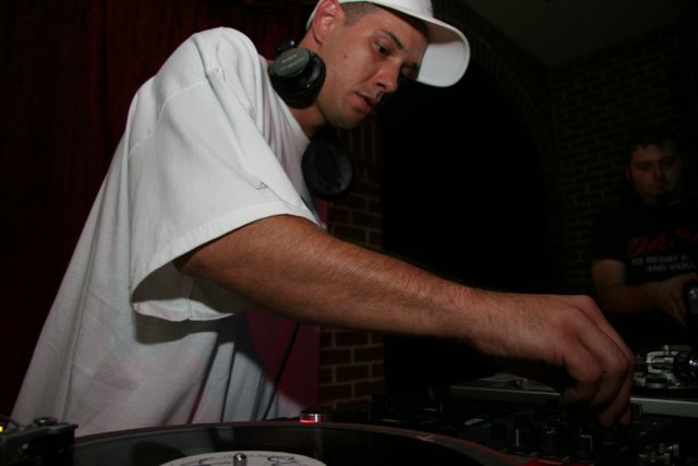 DJ S Spinning Tracks in White Tee