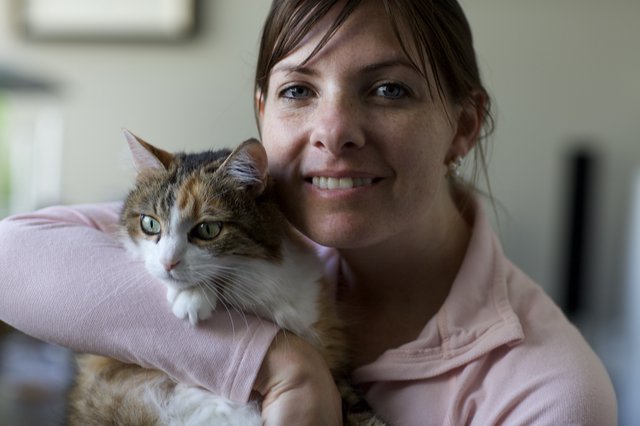 Woman and Her Calico Cat Share a Tender Moment