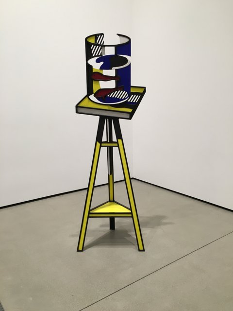 Yellow and Black Art Sculpture with Blue Chair