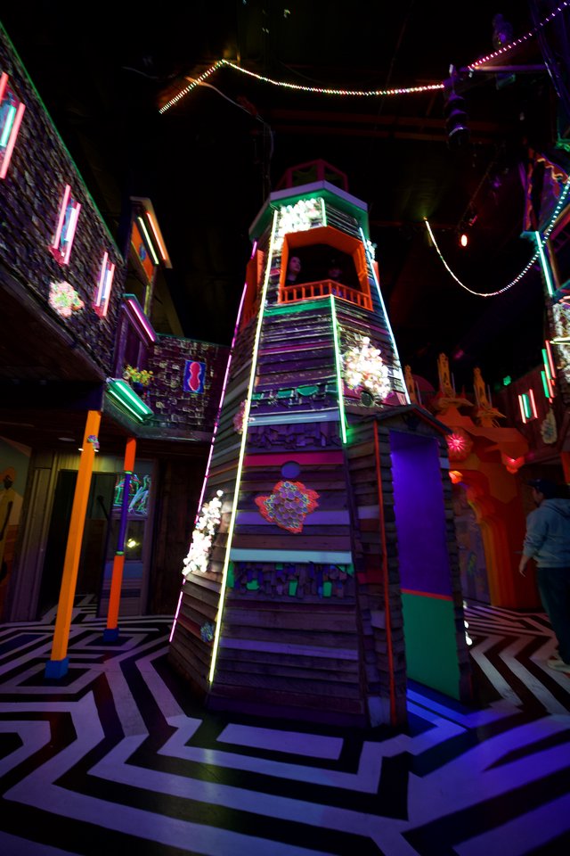 Vibrant Neon Tower Installation in Immersive Art Space