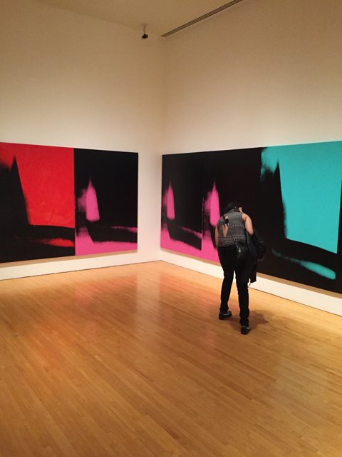 Man Contemplates Modern Art in Art Gallery