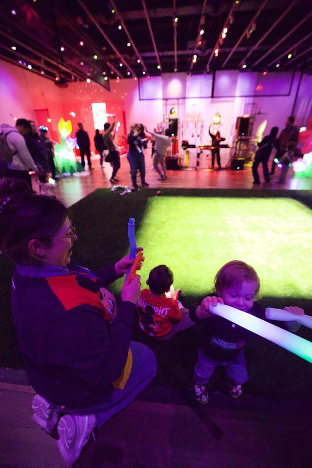Children Playing with Glow Sticks at Baby Rave Event