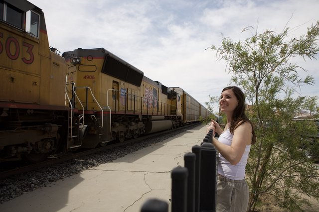Woman Smiles as Union Pacific Freight Train Passes