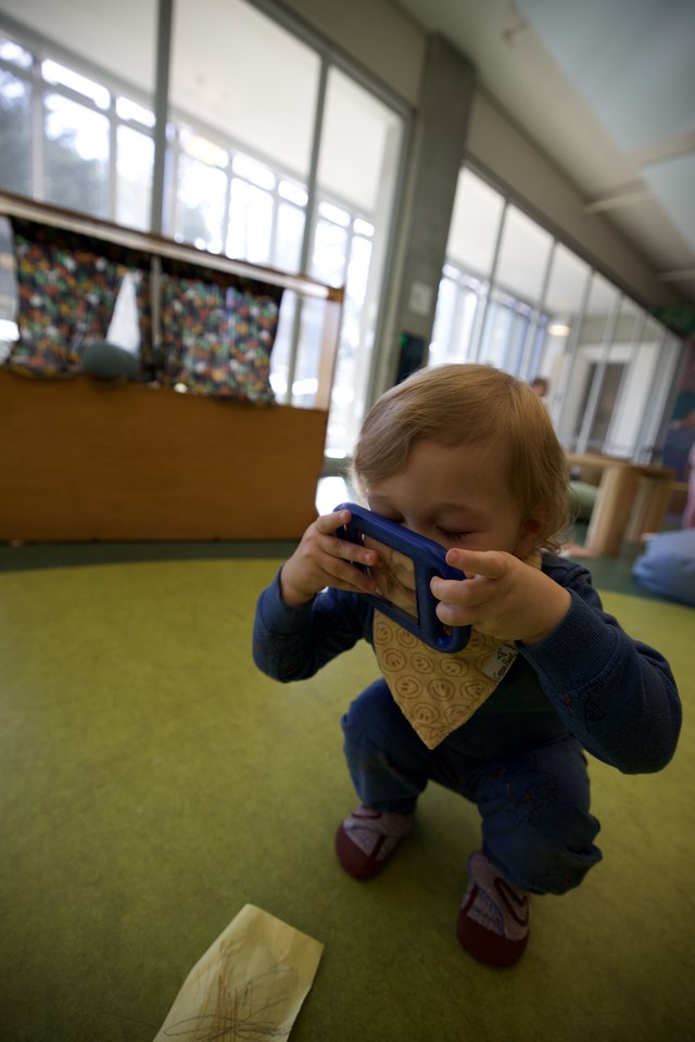 Young Child Taking Photo with Blue Tablet Device