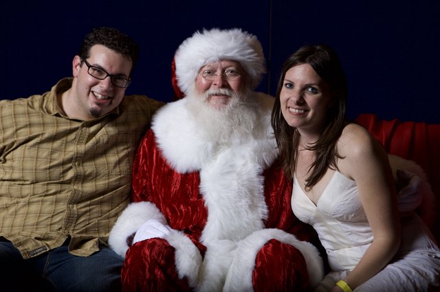 Adults Posing with Santa Claus at Christmas Party