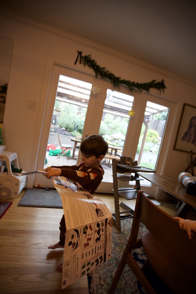 Child Building Cardboard Playhouse on Christmas Day