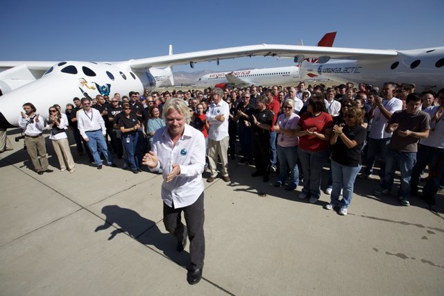 Richard Branson Stands Among the Crowd at Airfield