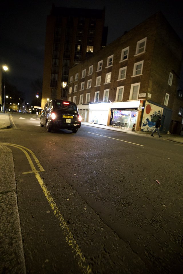 London Black Cab on Rain-Slicked Evening Street