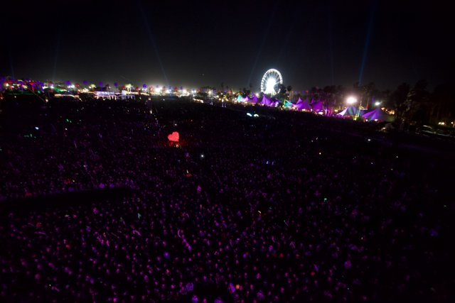 Nightlife in the Metropolis: Coachella Concertgoers bask under a Ferris Wheel