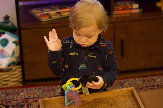 Toddler Concentrated on Toy During Christmas Morning Play
