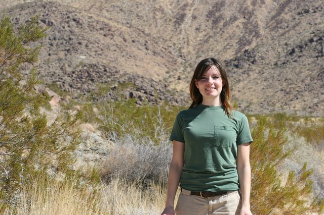 Young Woman Smiling in Arid Desert Landscape