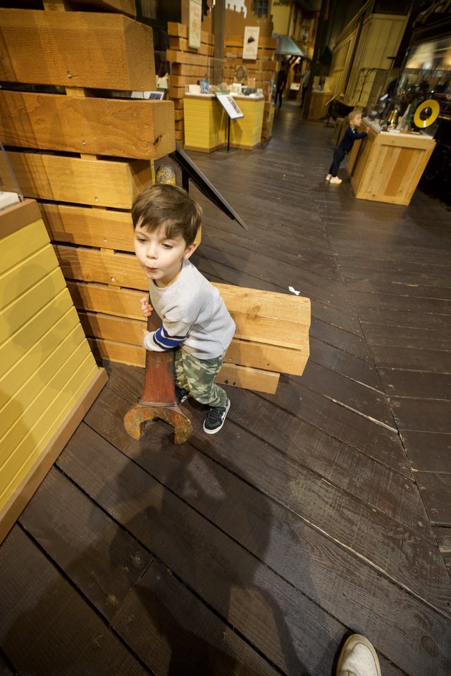 Young Boy Exploring Interactive Wood Construction Museum Exhibit