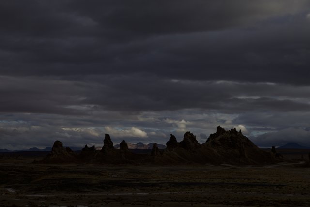 Desert Silhouettes Beneath a Cloudy Sky