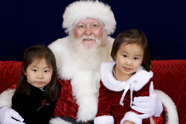 Santa Claus Spreads Christmas Joy with Two Little Girls