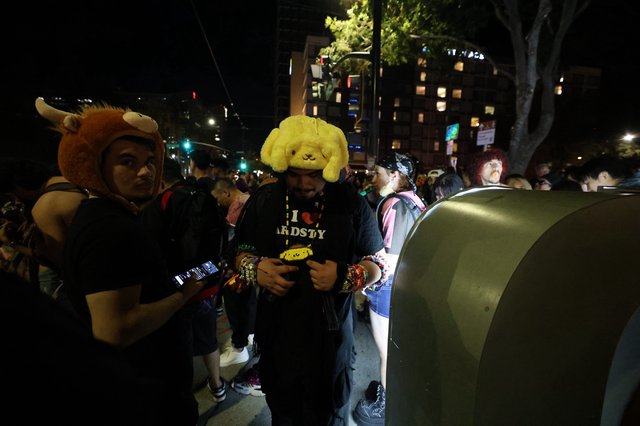 Costumed Ravers Navigate Night Festival Crowd Together