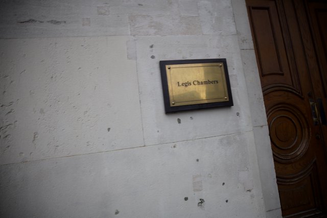 Legis Chambers Brass Plaque on Weathered White Wall