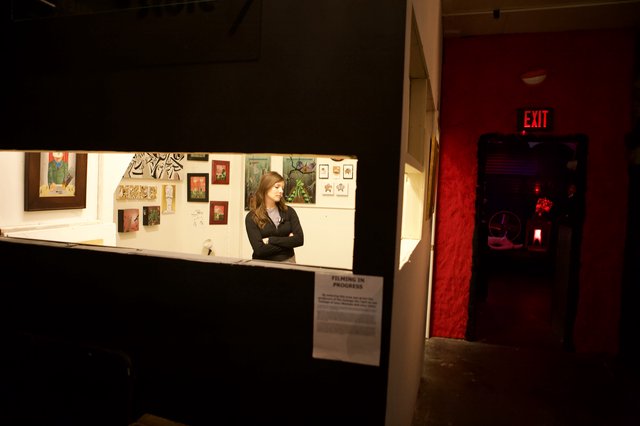 Gallery Attendant Watches Over Art Walk Exhibition