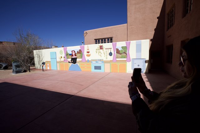 Woman Photographing Colorful Kitchen Mural in Santa Fe