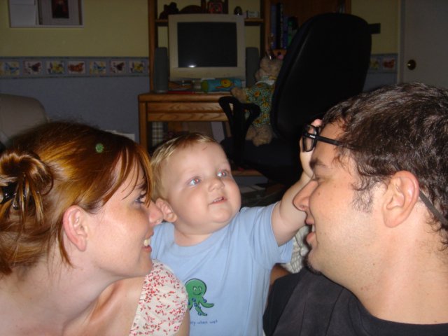 Baby's Curious Gaze Between Loving Parents