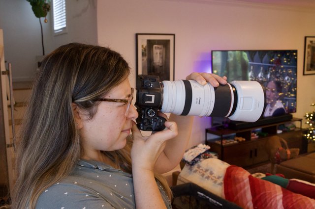 Photographer with Telephoto Lens in Home Studio
