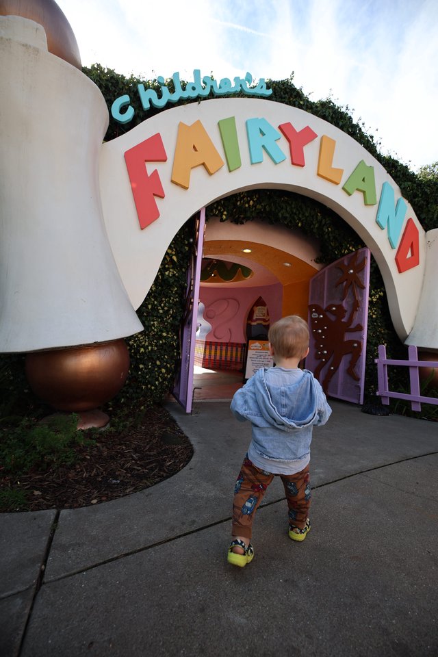 Child Entering Fairyland Play Structure at Theme Park