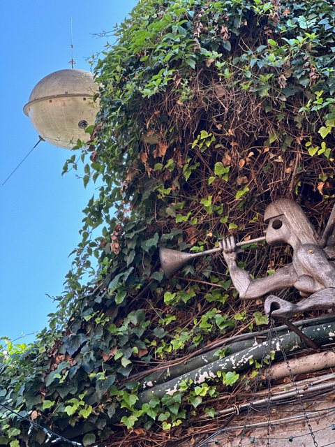 The Ivy-Covered Avian Statue