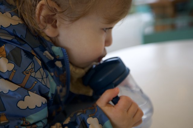 Young Child Peering Through Magnifying Glass in Wonder