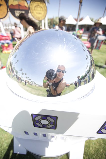 Reflections of a Sunglass-Wearing Man in a Metal Sphere