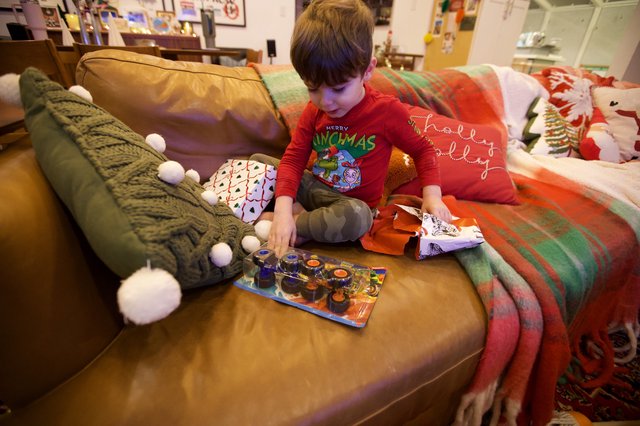 Child Opening Toy on Christmas Morning