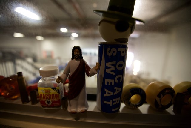 Jesus Figurine Amongst Trinkets and Toys