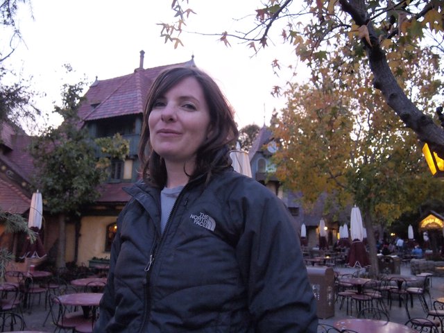 Woman in North Face Jacket at Twilight Courtyard