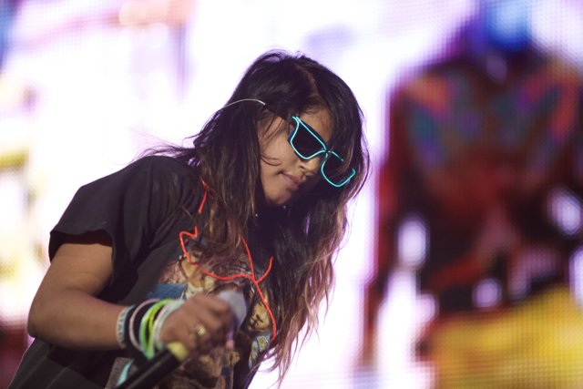 Woman Rocks the Stage in Sunglasses and Black