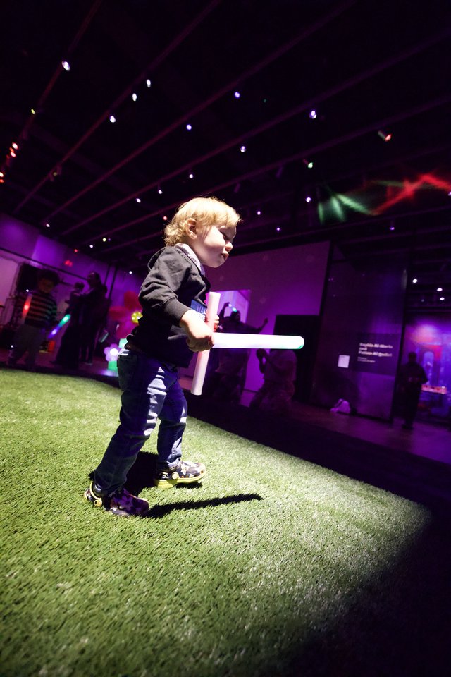 Toddler with Lightsaber at Baby Rave Event