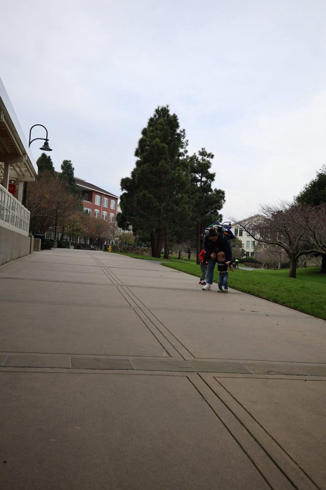 Family Walk Through Campus on Overcast Day